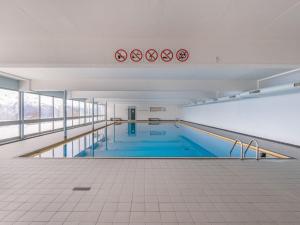 a large swimming pool in a large building at Studio Quille du Diable 4 by Interhome in Nendaz