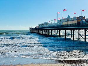 a pier on the beach next to the ocean at Seaside Homestay - Ensuite twin room with Kitchenette in Paignton