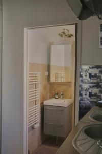 a bathroom with a sink and a mirror at Sacré coeur de ville in Lunel