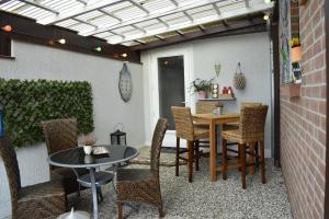 a patio with a table and some chairs and a table at Ferienhaus Heideglück in Bad Fallingbostel