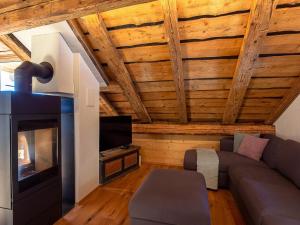 a living room with a couch and a fireplace at Apartment Ferienhaus Tgioc by Interhome in Obervaz