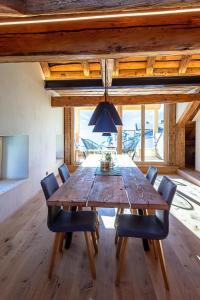 a dining room with a wooden table and chairs at Apartment Ferienhaus Tgioc by Interhome in Obervaz