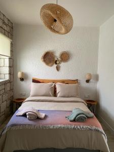 a bedroom with a bed with two towels on it at La Maison de Yasmine in Alaçatı +22 photos