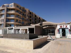 a large apartment building with a fountain in front of it at Princess resort unit number 260A Markos in Hurghada