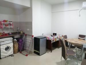 a kitchen with a table and a small table and a table and chairs at Princess resort unit number 260A Markos in Hurghada