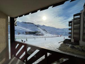 a view of a ski slope from a window at Beautiful apartment on the slopes in Val Thorens