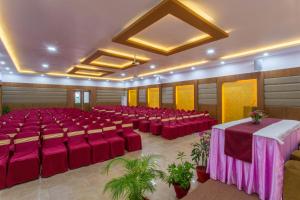 a large banquet hall with red tables and chairs at Atithi Resort & Spa in Pokhara