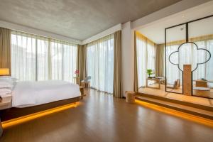a bedroom with a large bed and a large window at Argyle Boutique Hotel in Guangzhou