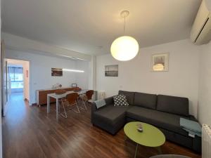 a living room with a couch and a table at August centro Tarragona in Tarragona