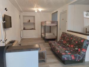 a living room with a couch and a table at Appartement Le Paradou à Besse in Besse-et-Saint-Anastaise