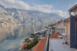 a balcony with a view of the water and mountains at Apartments Rozer in Kotor
