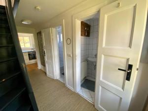 a bathroom with a white door and a sink at Gemütliches Ferienhaus im Extertal/ Lippe in Extertal +15 photos