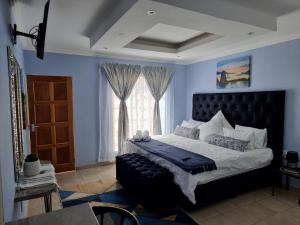 a bedroom with a large bed and a window at Danrit Guesthouse - Uncapped wifi in Roodepoort