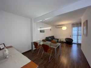 a living room with a table and a couch at August centro Tarragona in Tarragona