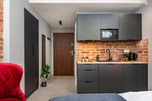 a kitchen with a sink and a brick wall at Felicjanek 15 - by Upstairs in Krakow