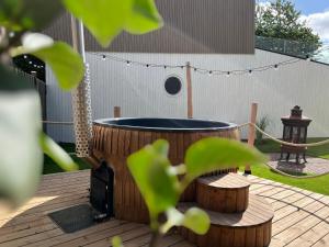 a hot tub sitting on a wooden deck with a fence at Ferienhaus Deluxe in Parey