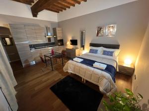 a bedroom with a bed and a living room at Domus San Martino GuestHouse in Piacenza