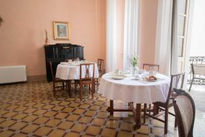 a dining room with two tables and chairs at Palazzo Zacà in Gallipoli