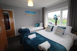 a hotel room with two beds and a window at Chadwick House in Sheffield