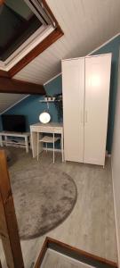 a room with a desk and a white cabinet at Studette Rémoise in Reims