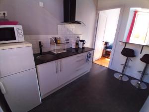 a kitchen with a sink and a microwave at Appart-Hotel Métro D Mermoz Lyon8 in Lyon