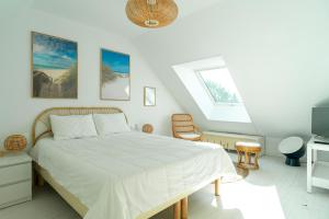 ein Schlafzimmer mit einem Bett mit einer weißen Tagesdecke in der Unterkunft Penn Odet - vue mer in Bénodet