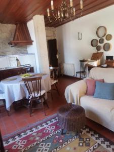 a living room with a table and a couch at Casa das Torres da Facha in Ponte de Lima