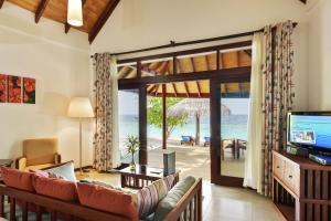 a living room with a view of the ocean at ROBINSON MALDIVES - Adults only in Gaafu Alifu Atoll