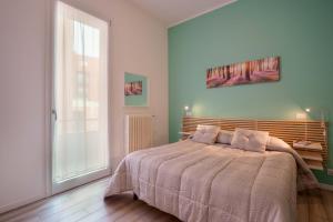 a bedroom with a bed and a large window at B&B Bentivogli in Bologna