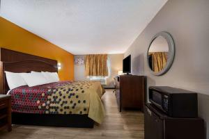 a hotel room with a bed and a mirror at Econo Lodge San Antonio near SeaWorld - Medical Center in San Antonio