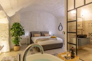 a master bedroom with a bed and a bathroom at Bright Stone con Vasca Jacuzzi in Monopoli