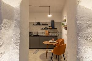 a kitchen with a table and chairs in a room at Bright Stone con Vasca Jacuzzi in Monopoli +18 photos