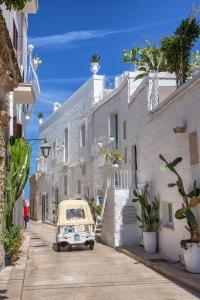 a car parked on a street with white buildings at Bright Stone con Vasca Jacuzzi in Monopoli