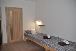 a bedroom with a bed with two pillows on it at Dom Gościnny BOROWIAK in Pobierowo