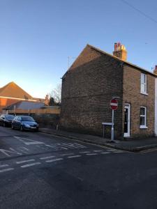a brick building with a stop sign on a street at Two Bedroom End Terrace House near Birchington High Street in Birchington