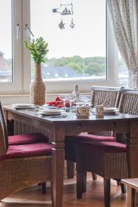 a dining room table with a vase on top of it at Vik1_23 in Westerland (Sylt)