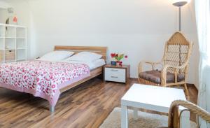 a bedroom with a bed and a chair and a table at Vik1_23 in Westerland (Sylt) +5 photos