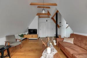 a living room with a couch and a table at City & Old Town View Rooftop by Downtown Apartments in Gdańsk