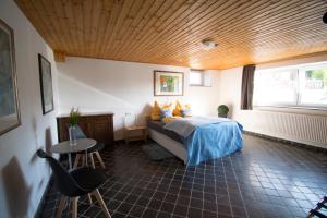 a bedroom with a bed and a table and a window at Ferienwohnung für 2 Personen mit direktem Zugang in Auw