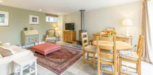 a living room with a couch and a table at Trewornan Manor in Wadebridge