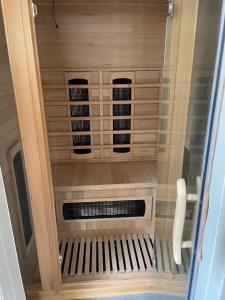 a sauna is shown in a glass door at Lochness Glam Lodges in Inverness