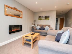 a living room with a couch and a fireplace at Beech Lodge in Preston