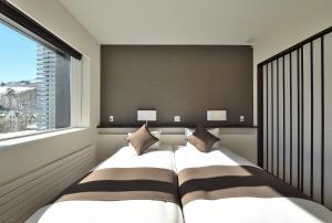 Giường trong phòng chung tại Mountain Side Hakuba
