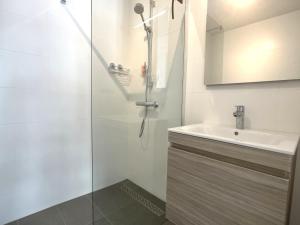 a bathroom with a shower and a sink at Lichthuys 2.02 in Cadzand +10 photos