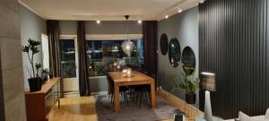 a dining room with a table with candles on it at Lund - Exellent Apartment in Tromsø