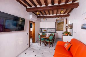 - un salon avec un canapé orange et une table dans l'établissement IBibiena - SUITE DEL CARDINALE, à Bibbiena