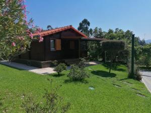 ein kleines Haus mit einem grünen Hof in der Unterkunft Kombi House in Terras de Bouro + 14 Fotos