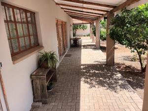 a hallway of a house with a bench and a window at Featherhouse in Colesberg