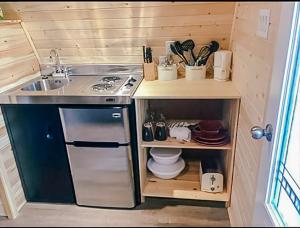 a small kitchen with a stove and a sink at Hillside Cottages in Bay Roberts