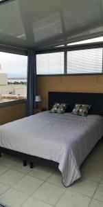 a bedroom with a large bed with a large window at 20 m2 de terrasse face à la mer à Canet en Roussillon in Canet-en-Roussillon